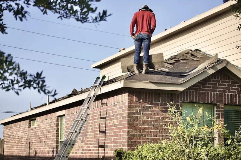 Professional roofer working on a residential roof in Imperial